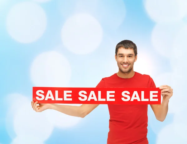 Woman in red dress with sale sign — Stock Photo, Image