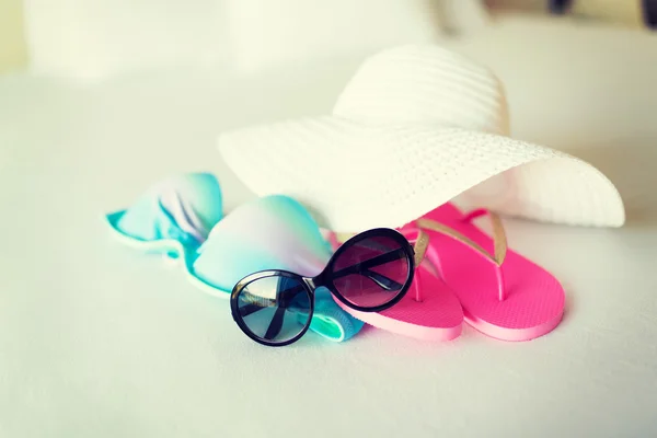 Top de biquíni, chapéu, chinelo e óculos de sol — Fotografia de Stock