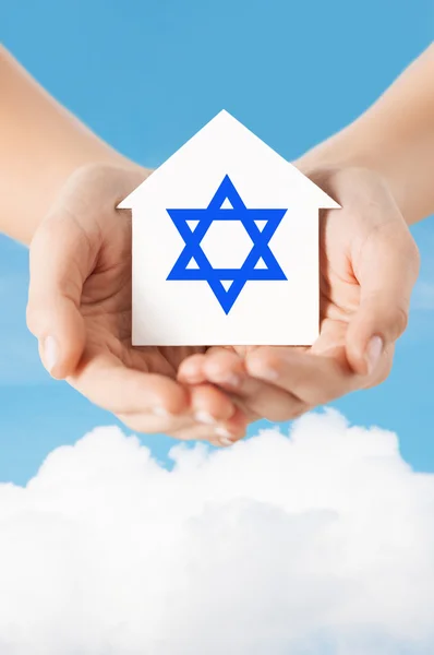 Close up of hands holding house with star of david — Stock Photo, Image