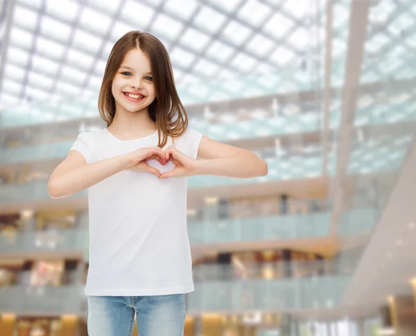 Smiling little girl in white blank t-shirt — Stock Photo, Image