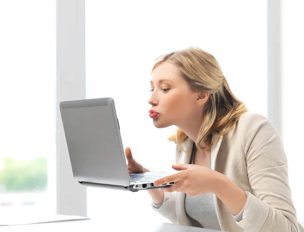 Woman sending kisses with laptop computer — Stock Photo, Image