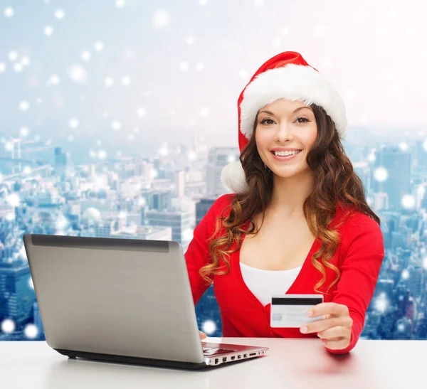 Mulher sorridente com cartão de crédito e laptop — Fotografia de Stock