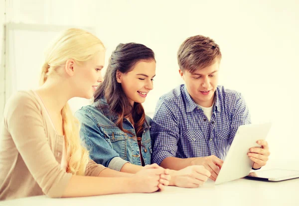 Smiling students with tablet pc computer at school — Stock Photo, Image