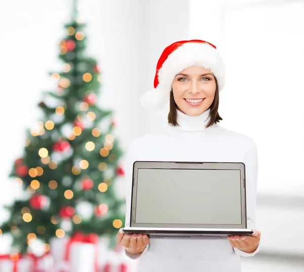 便携式计算机的圣诞老人 helper 帽子的女人 — 图库照片