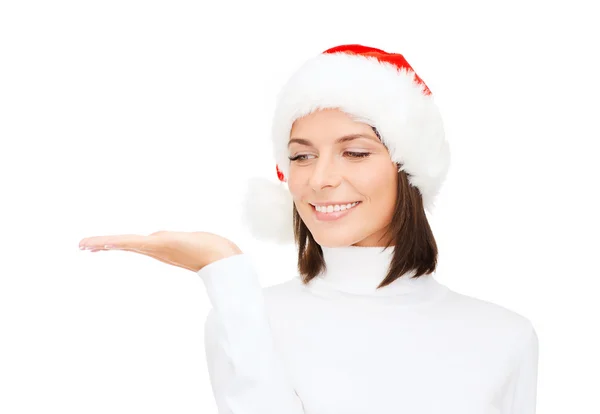 Woman in santa helper hat with something on palm — Stock Photo, Image