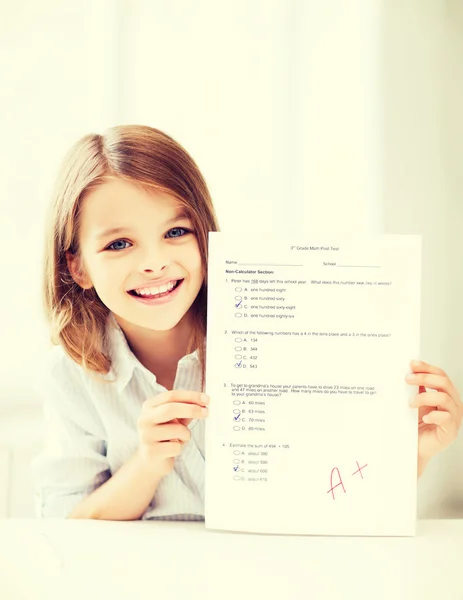Girl with test and grade at school — Stock Photo, Image