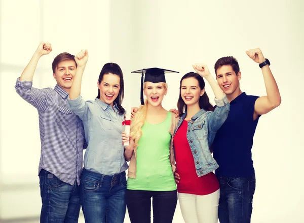 Group of standing smiling students with diploma — Stock Photo, Image