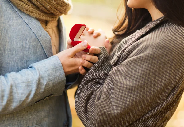 Close up of couple with gift box in park — Stock Photo, Image