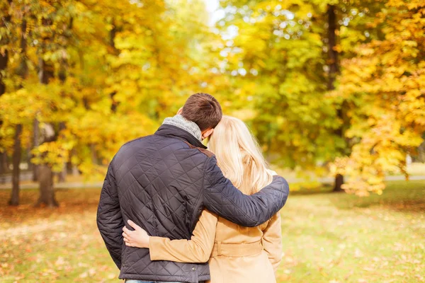 Casal abraçando no parque de outono de volta — Fotografia de Stock