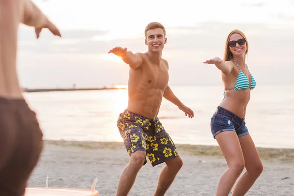 Улыбающиеся друзья в солнечных очках с серфингом на пляже — стоковое фото