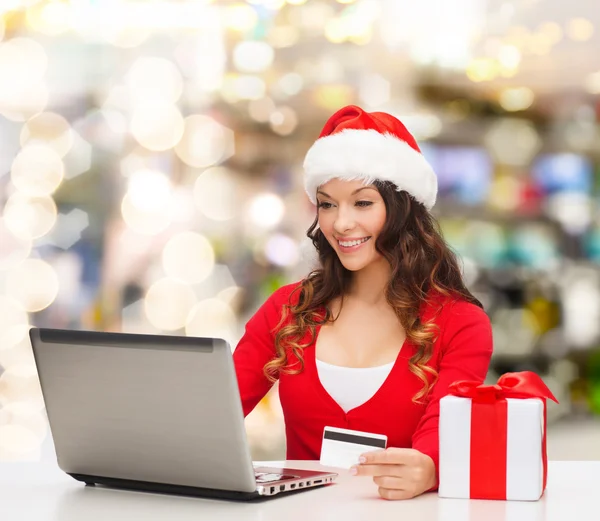 Mulher sorridente com cartão de crédito e laptop — Fotografia de Stock