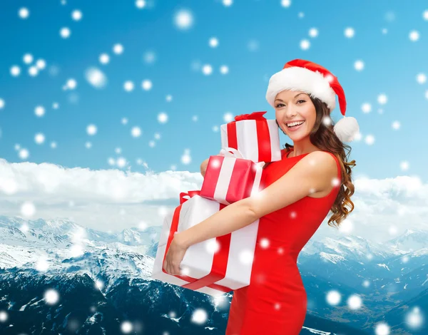 Smiling woman in red dress with gift box — Stock Photo, Image