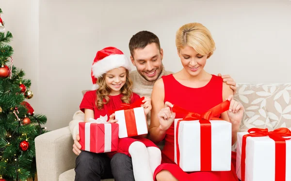 Happy family opening gift boxes — Stock Photo, Image