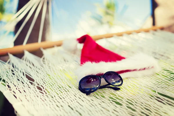 Hammock with santa helper hat and shades — Stock Photo, Image