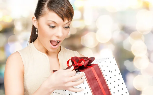 Smiling woman in red dress with gift box — Stock Photo, Image