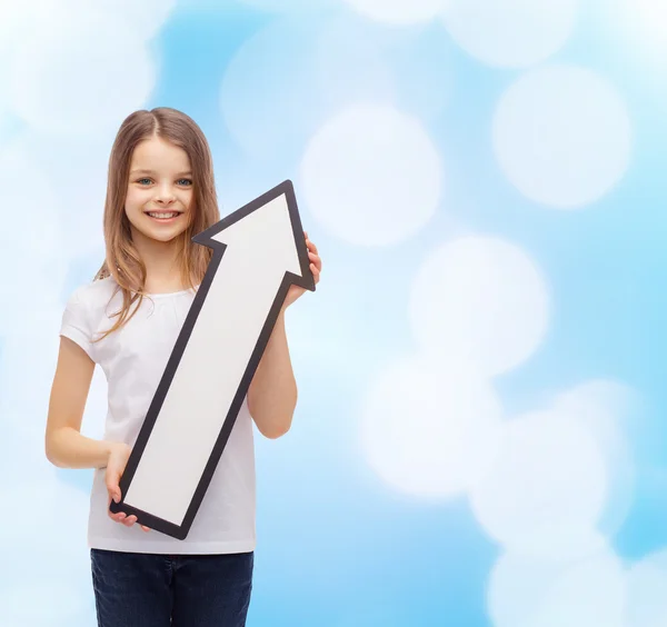 Smiling little girl with blank arrow pointing up — Stock Photo, Image