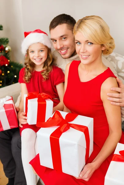Smiling family holding many gift boxes Royalty Free Stock Images