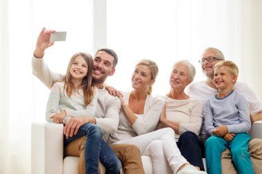 happy family with smartphone at home clipart