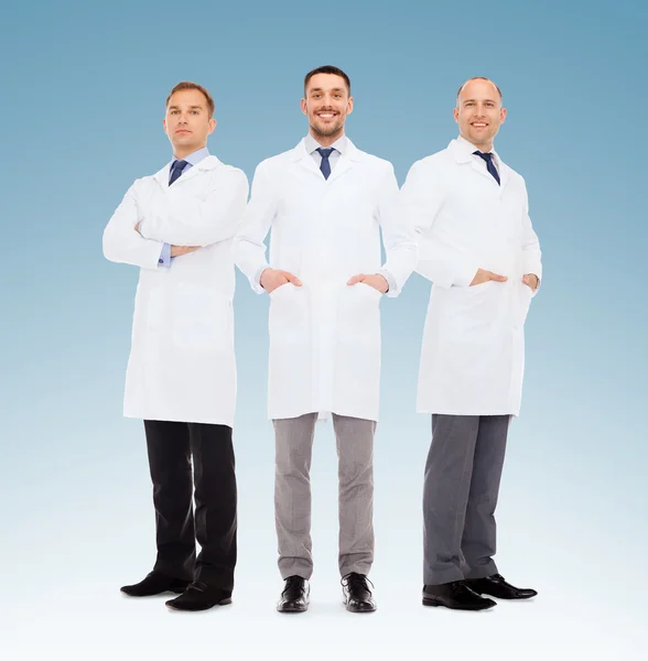 Group of smiling male doctors in white coats — Stock Photo, Image