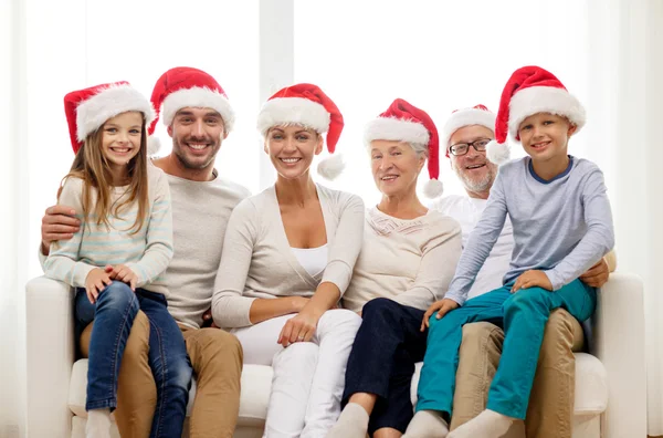 Happy family sitting on couch at home — Stock Photo, Image
