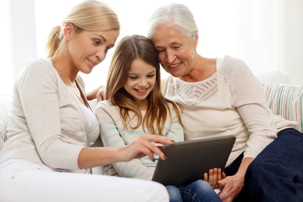 Smiling family with tablet pc at home — Stock Photo, Image
