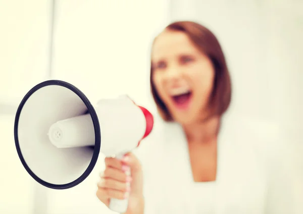 Strict businesswoman shouting in megaphone — Stock Photo, Image