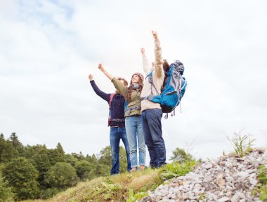 group of smiling friends with backpacks hiking clipart
