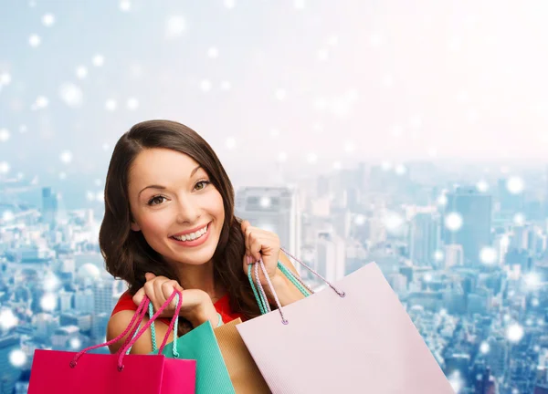 Smiling young woman with shopping bags — Stock Photo, Image