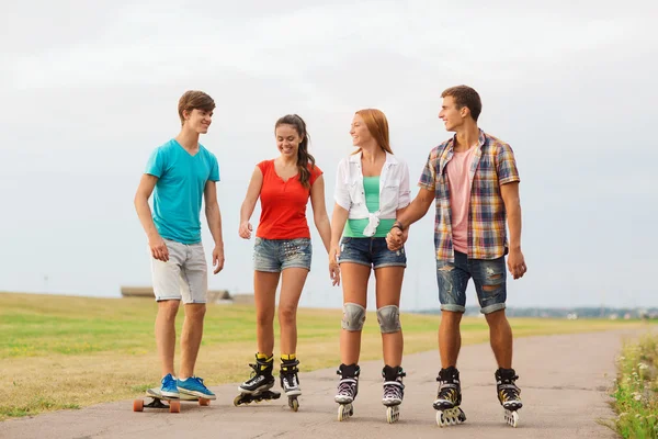 Groupe d'adolescents souriants avec patins à roulettes — Photo