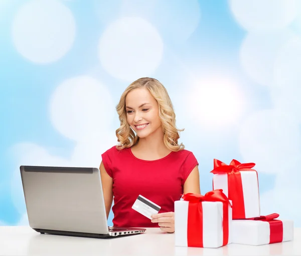 Mulher sorridente com cartão de crédito e laptop — Fotografia de Stock