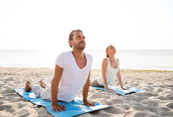 couple making yoga exercises outdoors