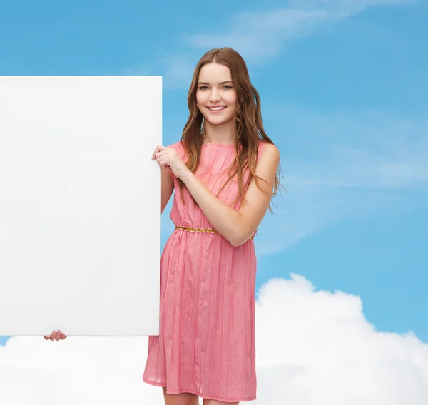 Mujer joven en vestido con tablero blanco en blanco — Foto de Stock