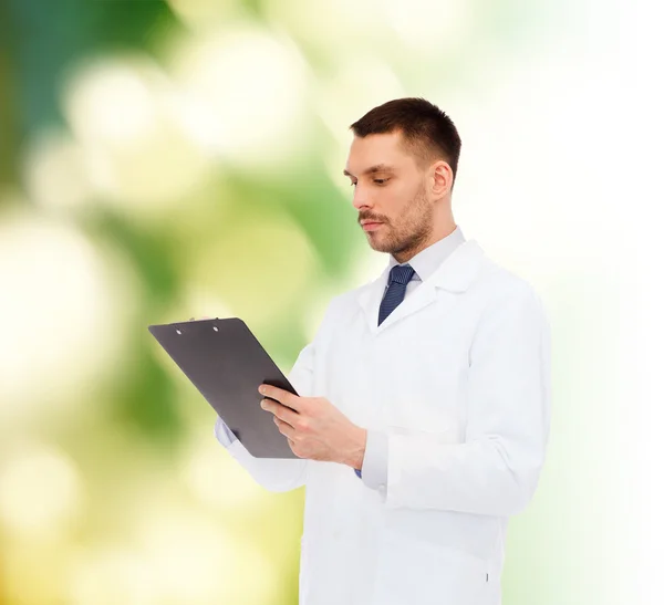 Serious male doctor with clipboard — Stock Photo, Image