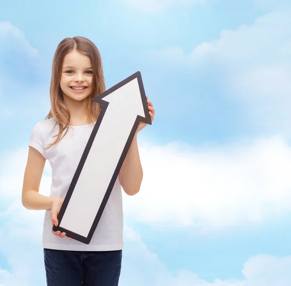 Smiling little girl with blank arrow pointing up — Stock Photo, Image