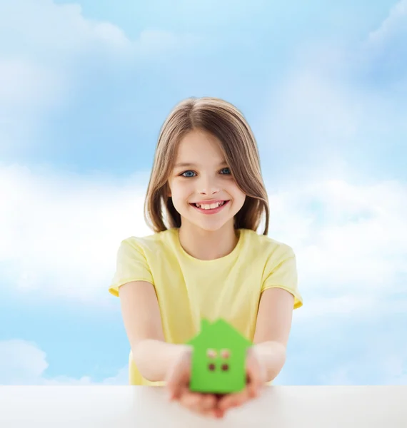 Beautiful little girl holding paper house cutout — Stock Photo, Image