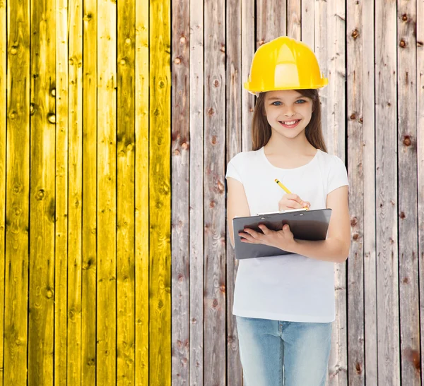 Sorridente bambina in hardhat con appunti — Foto Stock