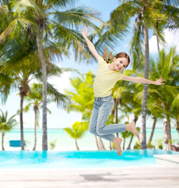 Smiling little girl jumping — Stock Photo, Image