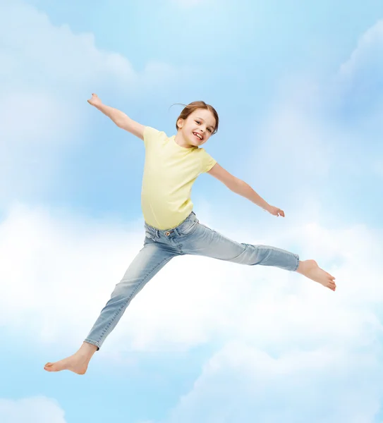 Smiling little girl jumping — Stock Photo, Image