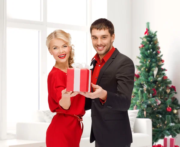 Усміхнений чоловік і жінка з подарунком — стокове фото