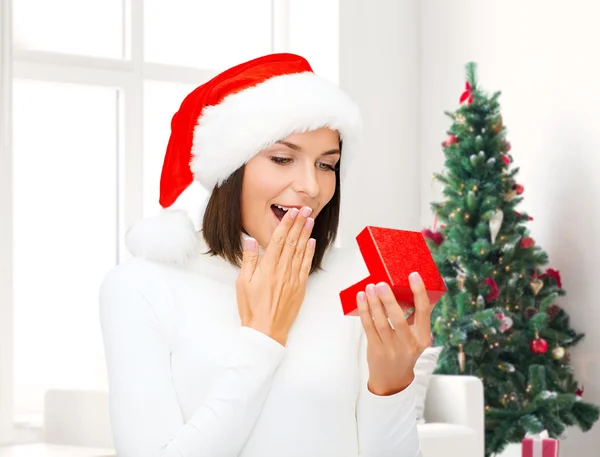 Mujer sonriente en sombrero de ayudante de santa con caja de regalo — Foto de Stock