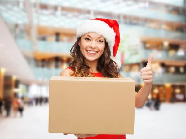 Smiling woman in santa helper hat with parcel box — Stock Photo, Image