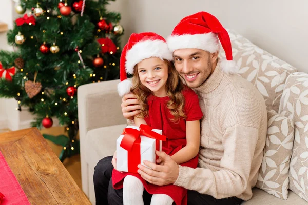 Leende far och dotter håller presentförpackning — Stockfoto