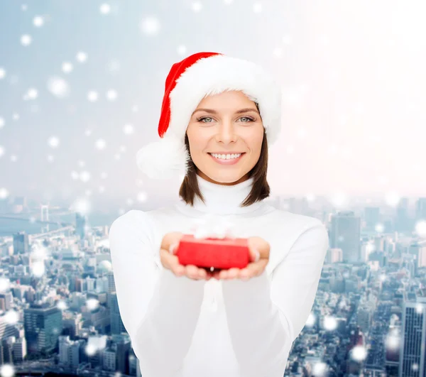 Mujer sonriente en sombrero de ayudante de santa con caja de regalo — Foto de Stock