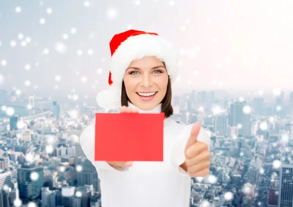 Mujer en sombrero de ayudante de santa con tarjeta roja en blanco — Foto de Stock