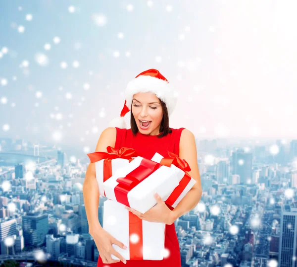 Smiling woman in red dress with gift box — Stock Photo, Image