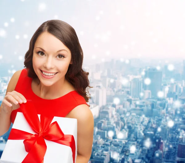 Smiling woman in red dress with gift boxes — Stock Photo, Image