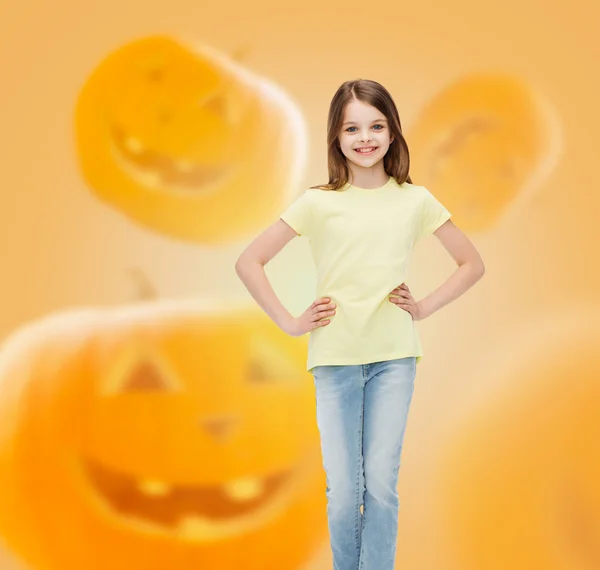Smiling girl over pumpkins background — Stock Photo, Image