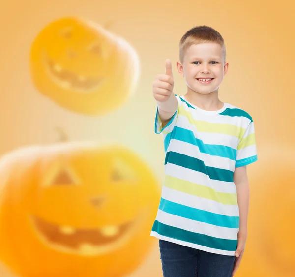 Smiling boy over pumpkins background — Stock Photo, Image