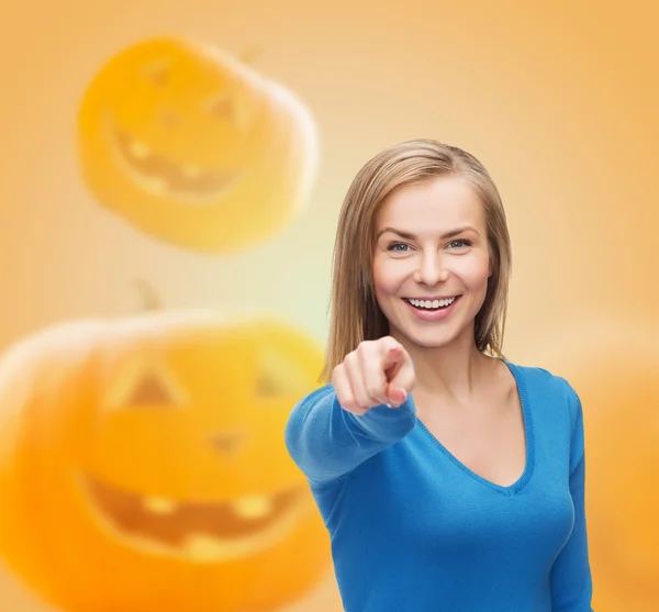 Smiling young woman pointing finger at you — Stock Photo, Image