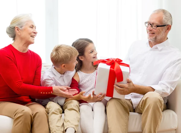 Familia sonriente con regalos en casa — Foto de Stock